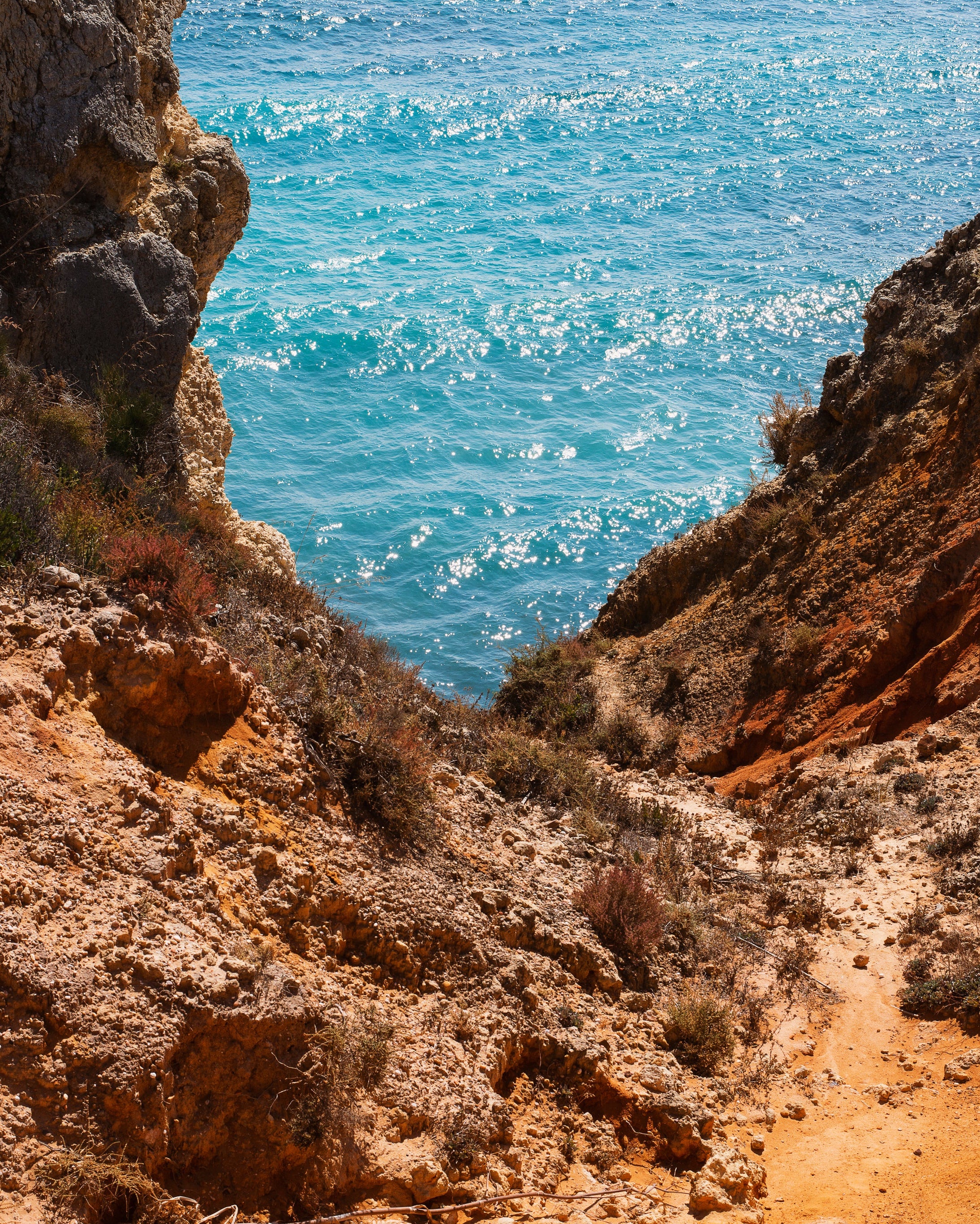 a-view-of-the-sea-from-a-rocky-cliff-side.jpg